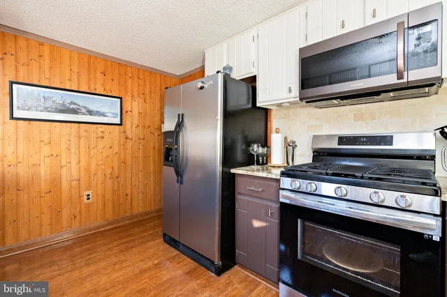 a large kitchen with cabinets and stainless steel appliances