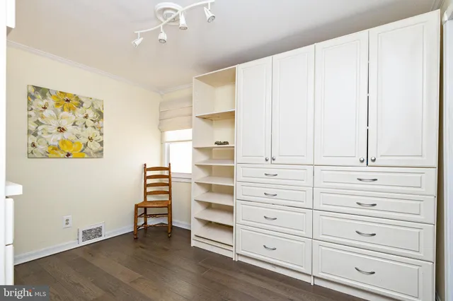 a living room with furniture rug and wooden floor