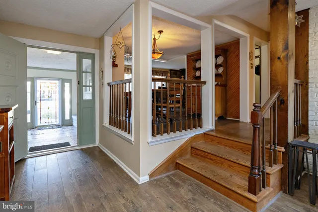 a view of a dining room with furniture wooden floor and a chandelier