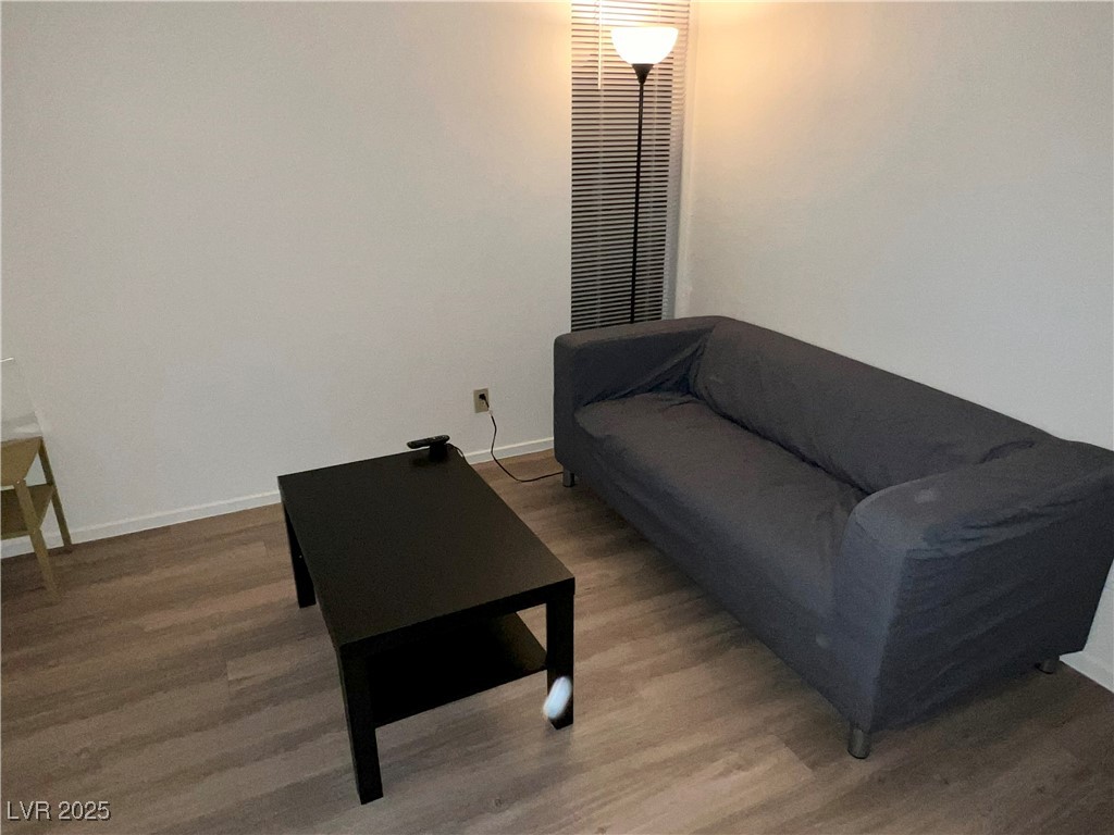 4650 Koval Lane, Unit 14C Las Vegas, NV 89109 - Photo 11 of 14 Living area with baseboards and wood finished floors