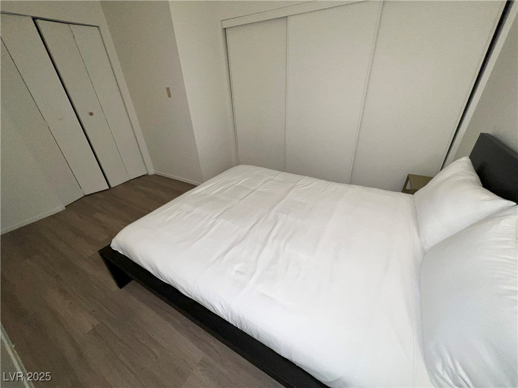 4650 Koval Lane, Unit 14C Las Vegas, NV 89109 - Photo 4 of 14 Bedroom with dark wood finished floors and baseboards