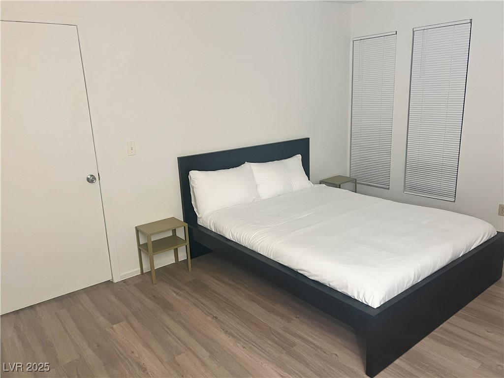 4650 Koval Lane, Unit 14C Las Vegas, NV 89109 - Photo 5 of 14 Bedroom featuring wood finished floors