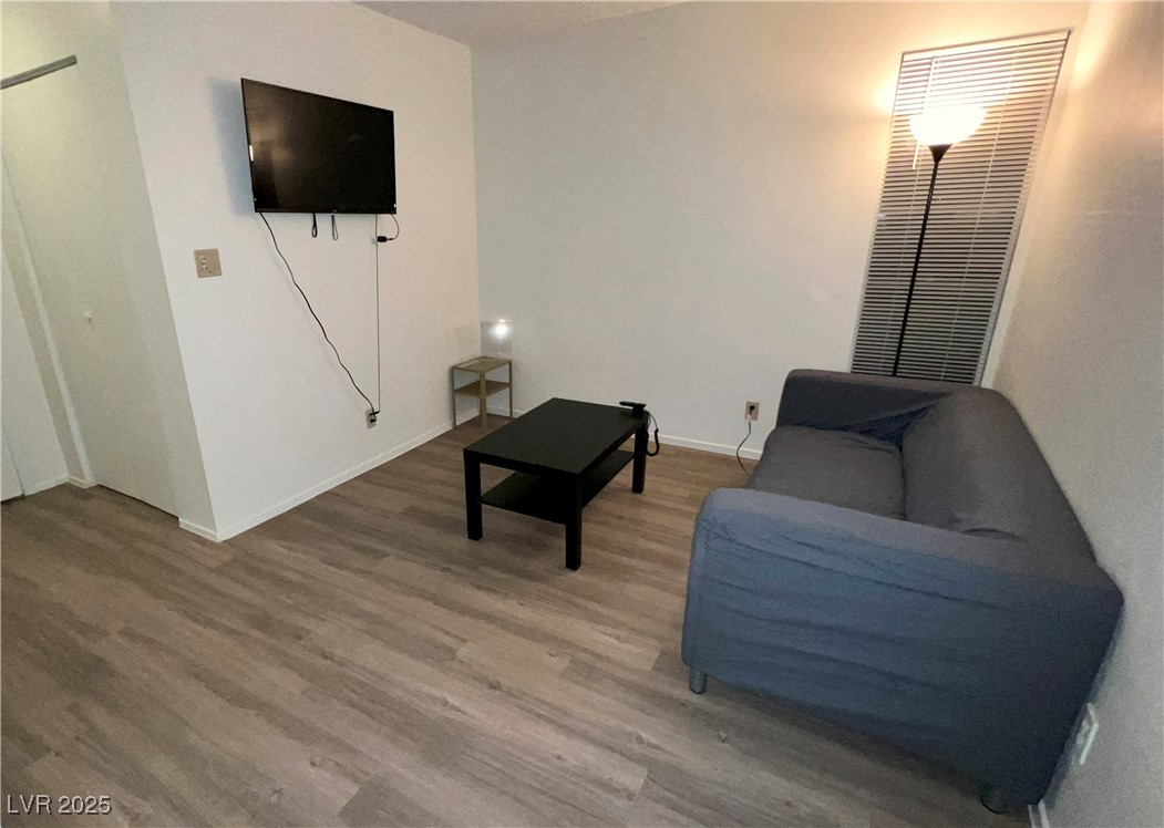 4650 Koval Lane, Unit 14C Las Vegas, NV 89109 - Photo 10 of 14 Living area with wood finished floors and baseboards