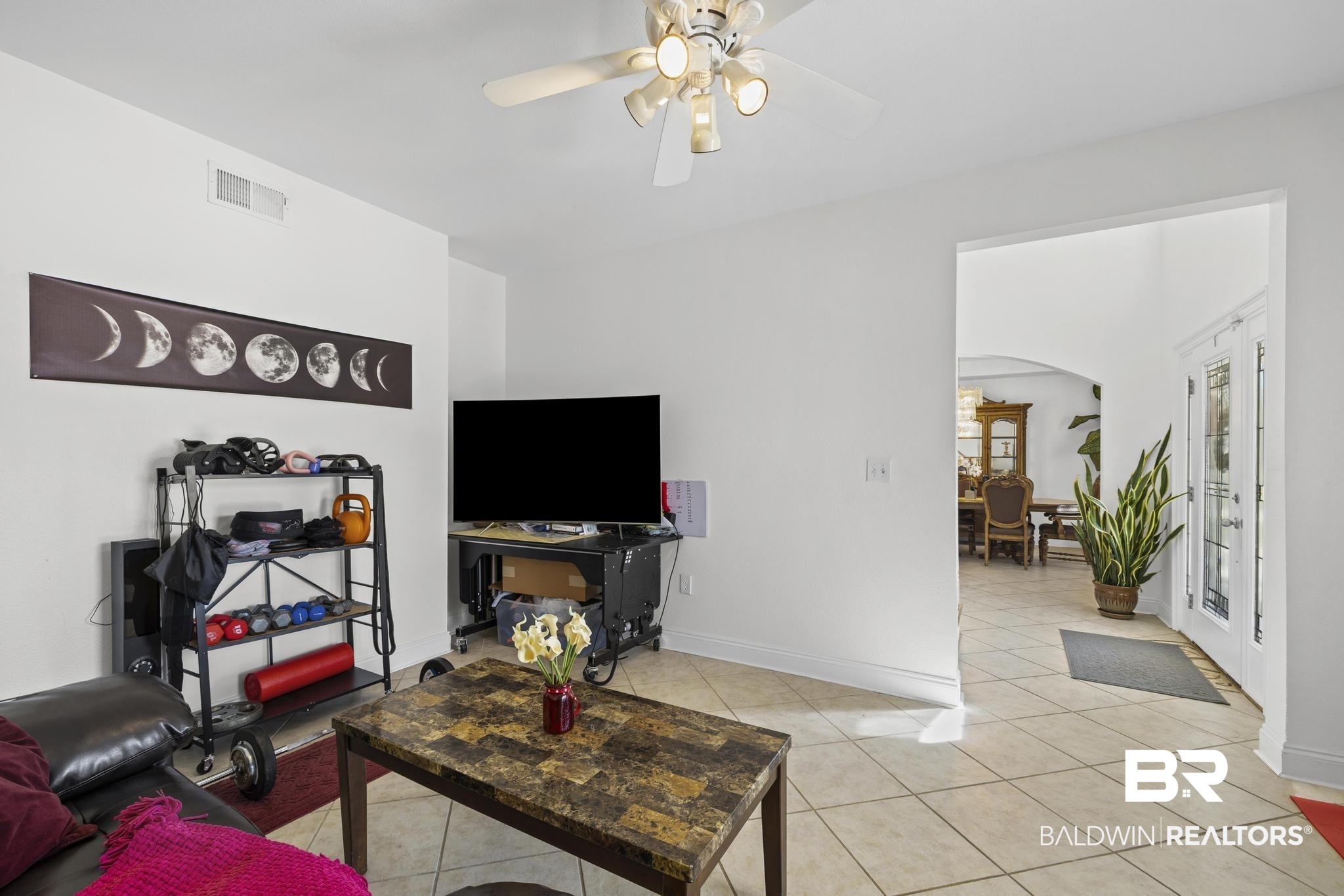 32875 Faircloth Road Lillian, AL 36549 - Photo 31 of 85 Living room featuring arched walkways, ceiling fan, and light tile patterned floors