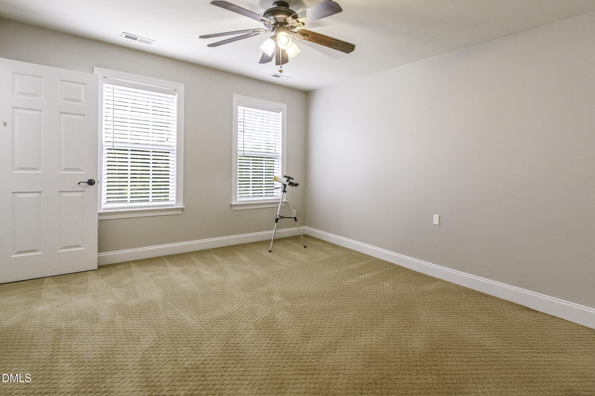 201 Quarryrock Road Holly Springs, NC 27540 - Photo 22 of 34 an empty room with chandelier fan and windows
