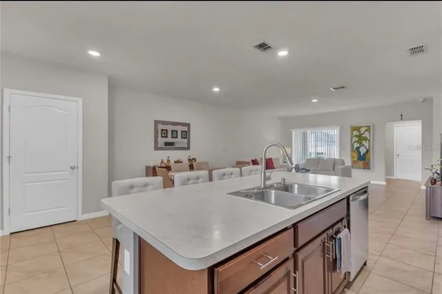a view of kitchen island a sink and living room