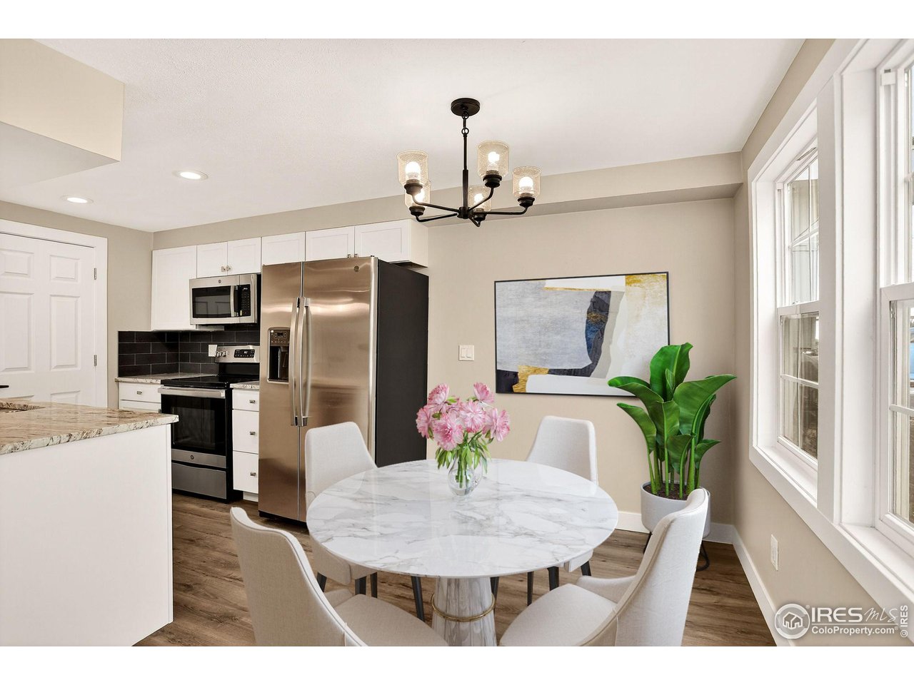 3360 34th Street, Unit B Boulder, CO 80301 - Photo 2 of 22 a kitchen with stainless steel appliances kitchen island granite countertop a refrigerator a stove a sink dishwasher with a dining table and chairs