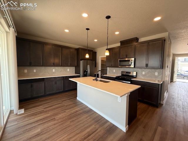 459 Atchison Way Calhan, CO 80808 - Photo 2 of 11 a large kitchen with stainless steel appliances kitchen island granite countertop a stove a sink dishwasher and a microwave oven with wooden floor