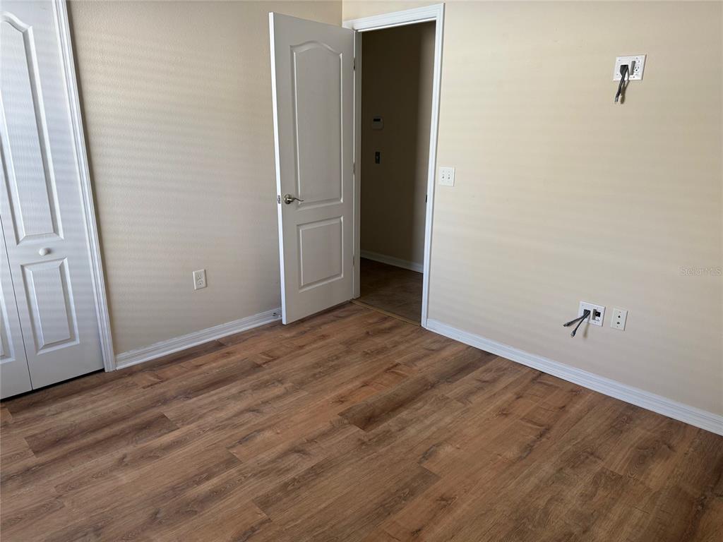 12311 Boot Spur Way Spring Hill, FL 34610 - Photo 14 of 25 an empty room with wooden floor and closet