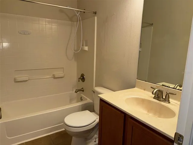 a view of an empty room with a fireplace and a window