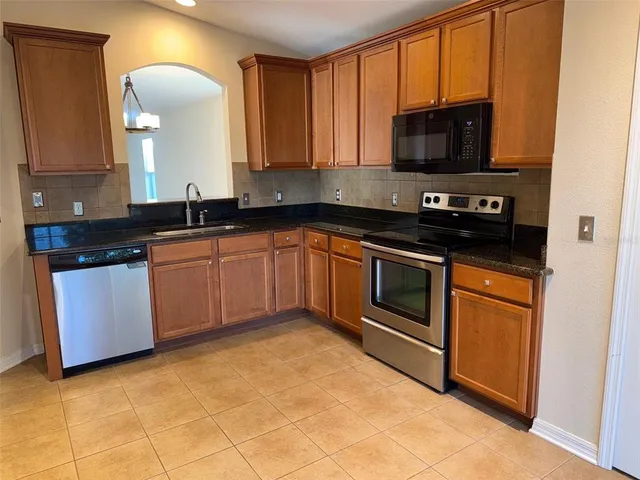 a kitchen with stainless steel appliances stove microwave and sink