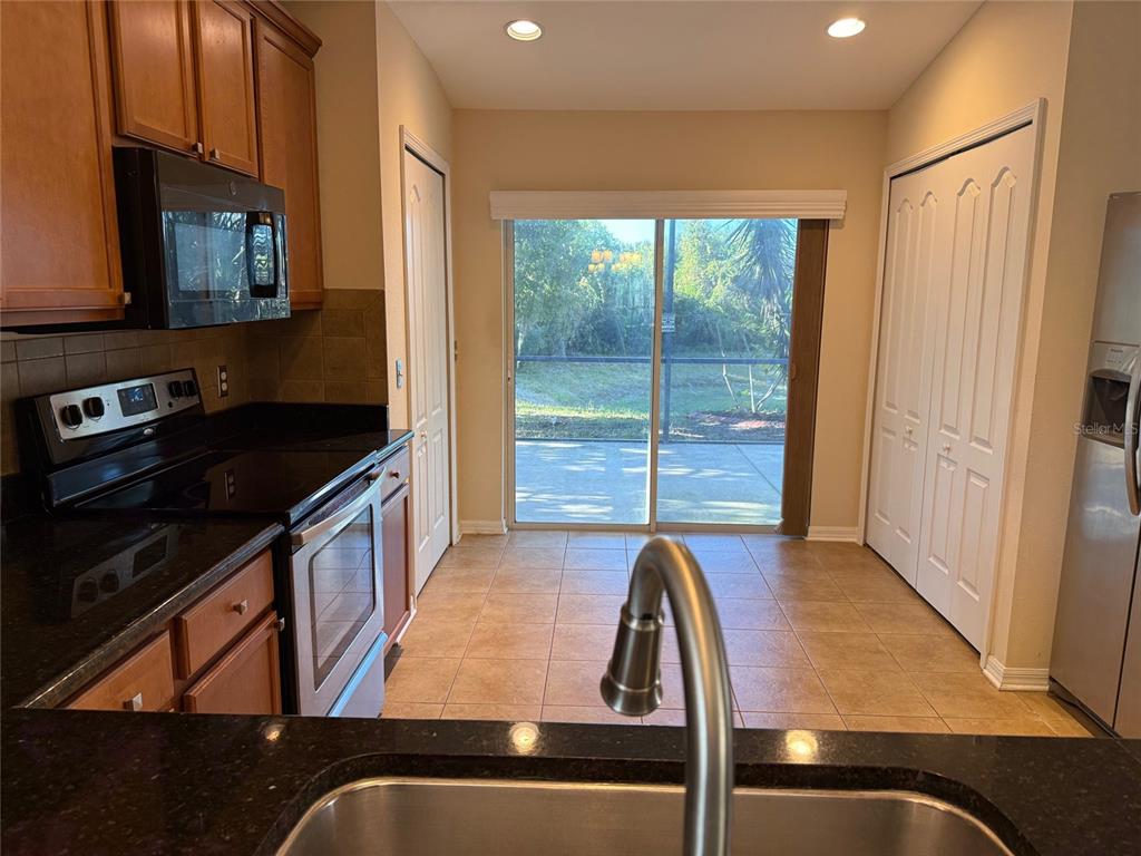 12311 Boot Spur Way Spring Hill, FL 34610 - Photo 7 of 25 a kitchen with wooden cabinets and a stove