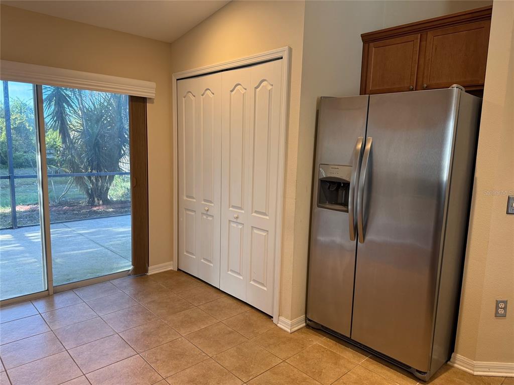 12311 Boot Spur Way Spring Hill, FL 34610 - Photo 9 of 25 a view of a refrigerator in kitchen and wooden floor