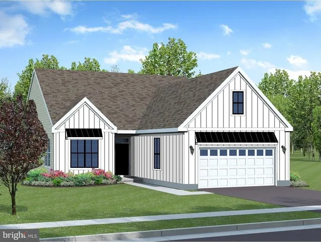 a view of a house with a yard and potted plants