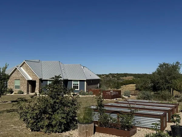 a front view of a house with a garden
