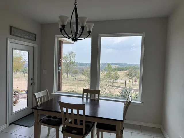a view of a dining room with furniture window and outside view