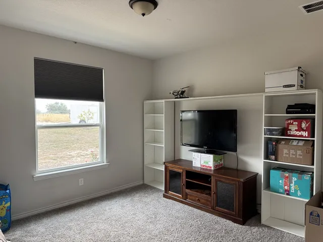 a living room with a flat screen tv and a fireplace
