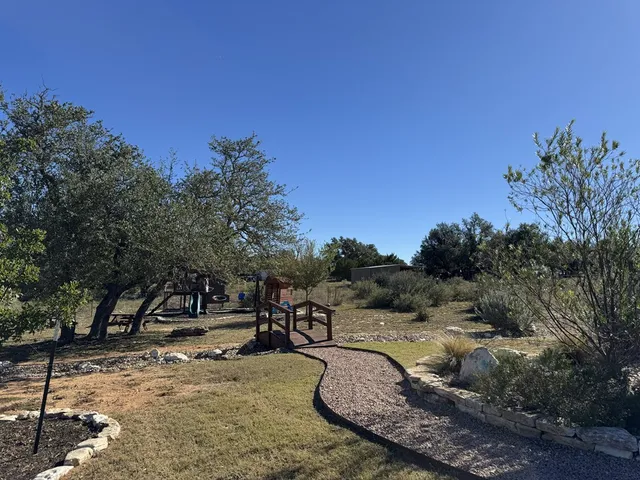 a view of a yard with table and chairs