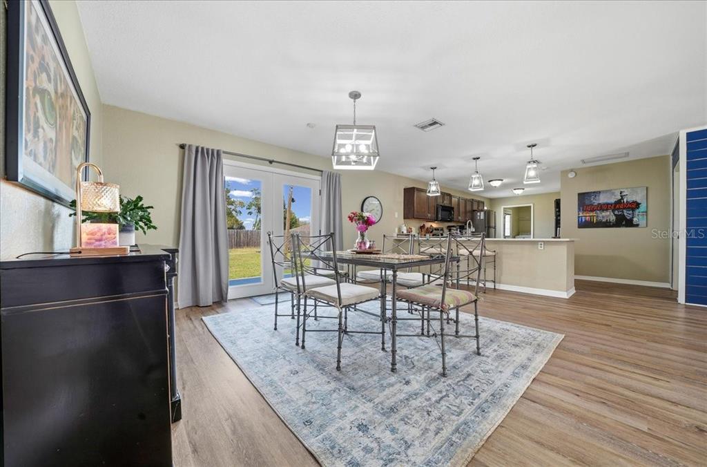 685 Northwest 67th Place Ocala, FL 34475 - Photo 11 of 33 a view of a dining room with furniture and wooden floor