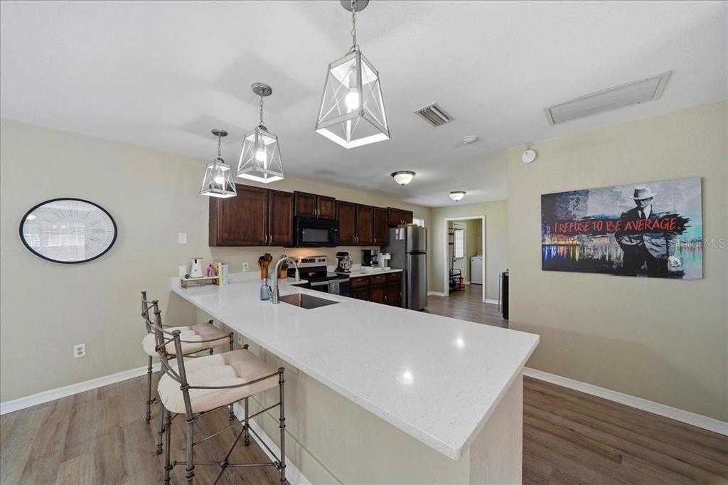 685 Northwest 67th Place Ocala, FL 34475 - Photo 14 of 33 a view of a dining room with furniture a chandelier and wooden floor