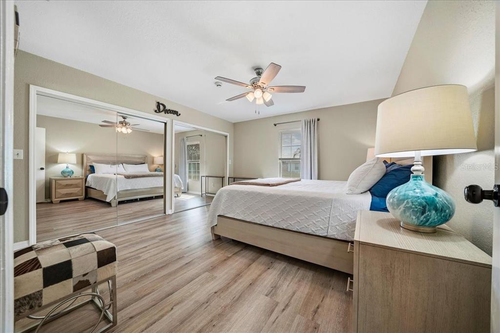 685 Northwest 67th Place Ocala, FL 34475 - Photo 16 of 33 a spacious bedroom with a bed and wooden floor