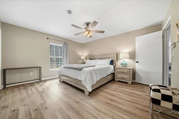 a bedroom with a bed and wooden floor