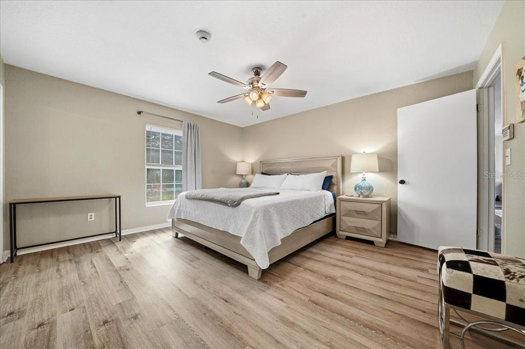 685 Northwest 67th Place Ocala, FL 34475 - Photo 17 of 33 a bedroom with a bed and wooden floor