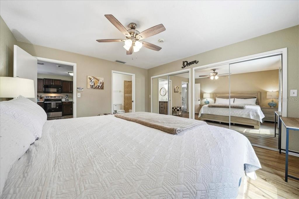 685 Northwest 67th Place Ocala, FL 34475 - Photo 18 of 33 a bedroom with a bed and a mirror