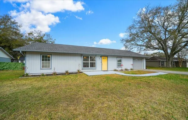 a view of a house with a yard and garage