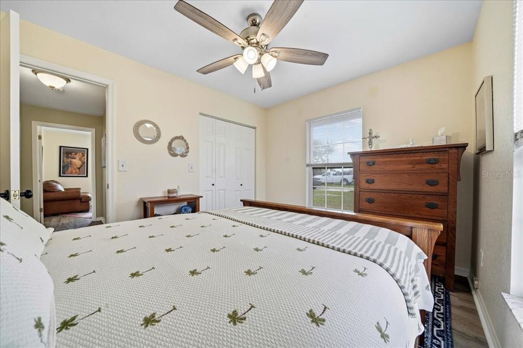 685 Northwest 67th Place Ocala, FL 34475 - Photo 23 of 33 a bedroom with a bed and a chandelier