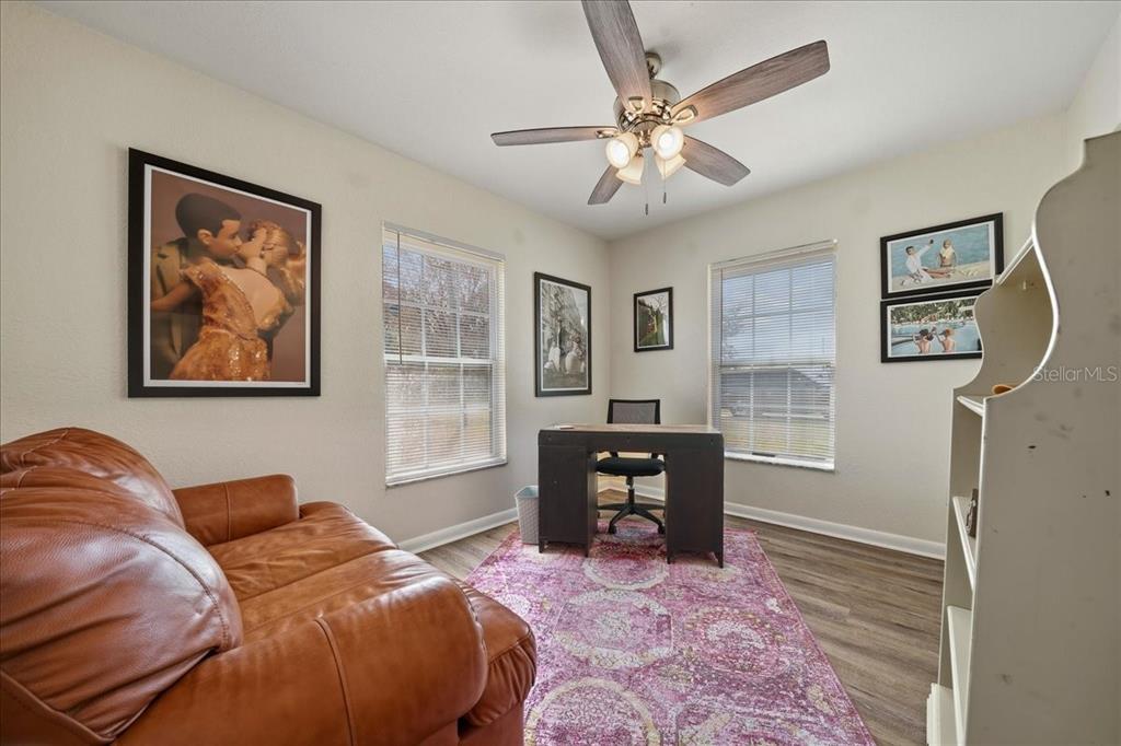 685 Northwest 67th Place Ocala, FL 34475 - Photo 25 of 33 a bedroom with a bed and a chandelier