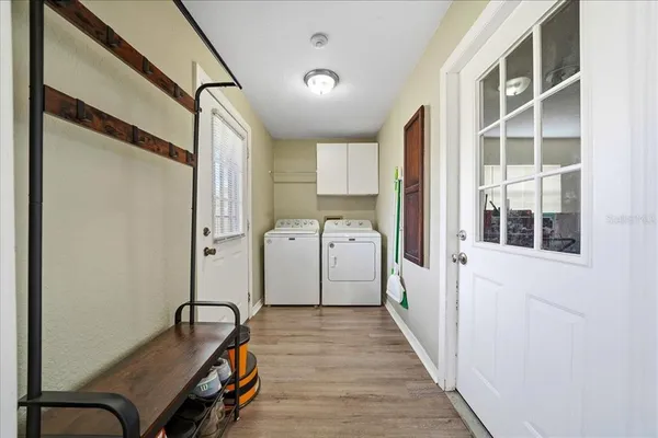 a hallway with a large window and wooden floor