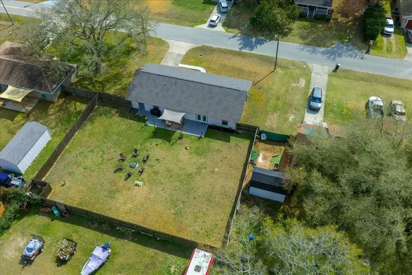 an aerial view of a house with a yard basket ball court
