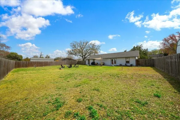 a front view of house with yard and lake
