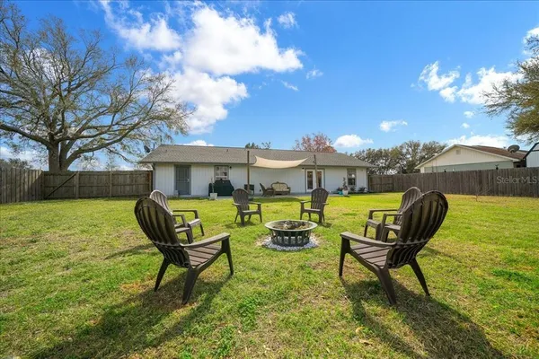 a view of a backyard with table and chairs