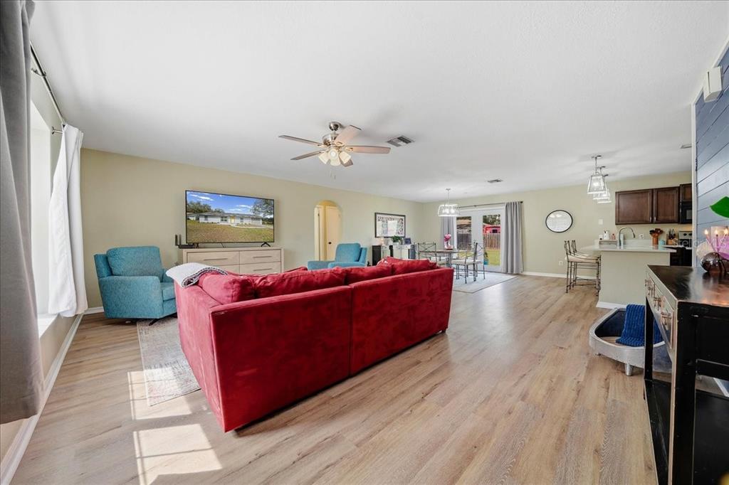 685 Northwest 67th Place Ocala, FL 34475 - Photo 8 of 33 a living room with furniture and a flat screen tv