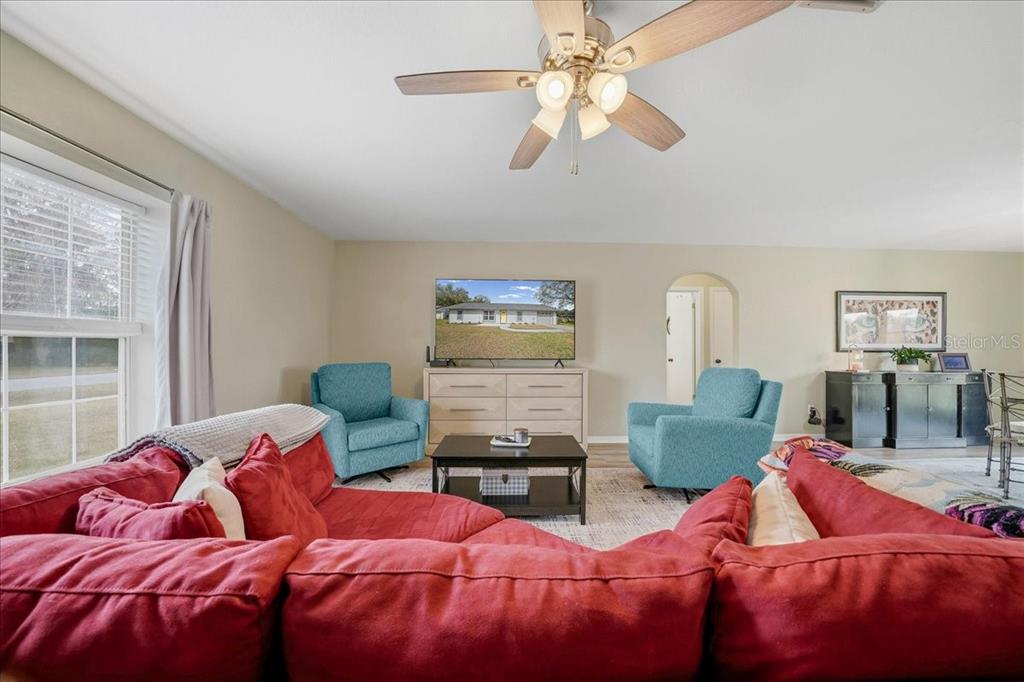 685 Northwest 67th Place Ocala, FL 34475 - Photo 9 of 33 a bedroom with two beds and a chandelier