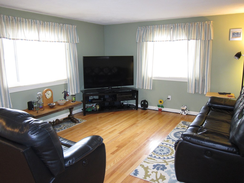 136 Mountain Gate Road, Unit 136 Ashland, MA 01721 - Photo 3 of 23 a living room with furniture and a flat screen tv