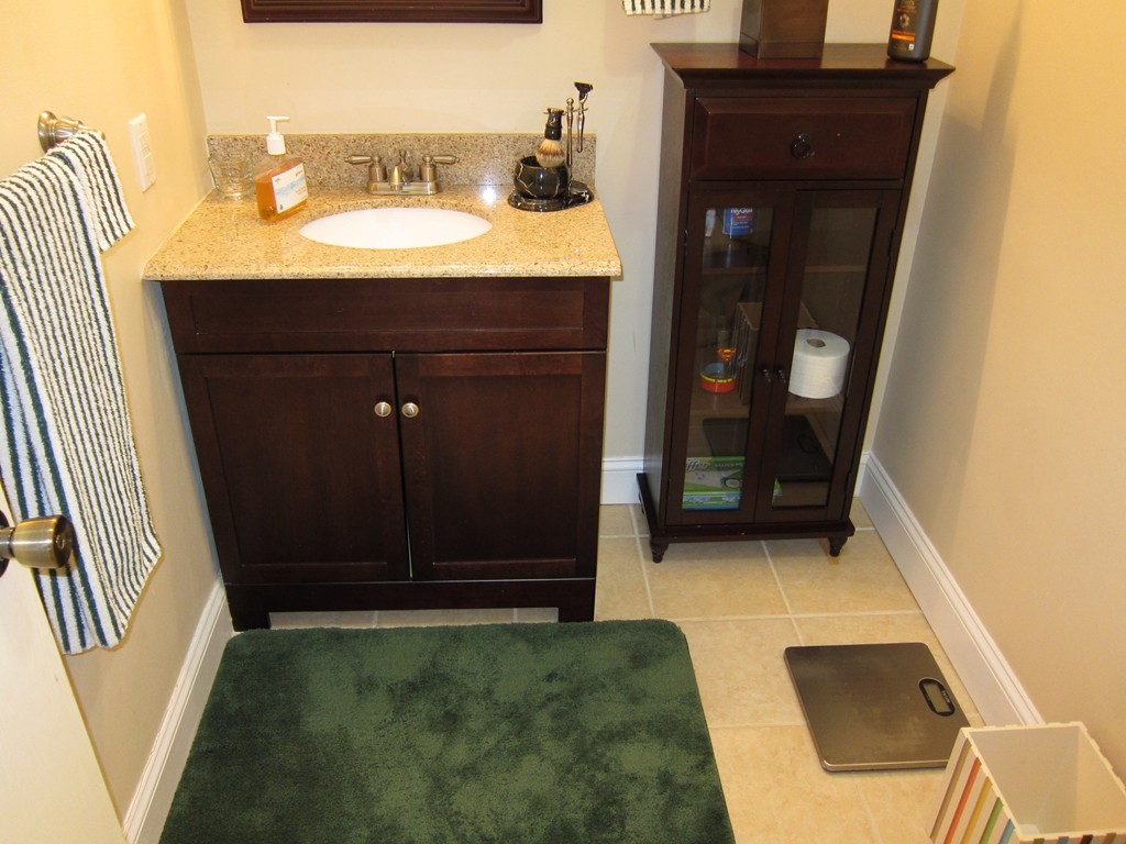 136 Mountain Gate Road, Unit 136 Ashland, MA 01721 - Photo 7 of 23 a bathroom with a sink and a mirror