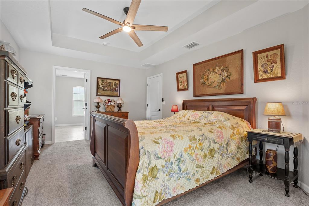 12929 Southwest 89th Street Dunnellon, FL 34432 - Photo 22 of 76 a bedroom with a bed and a chandelier
