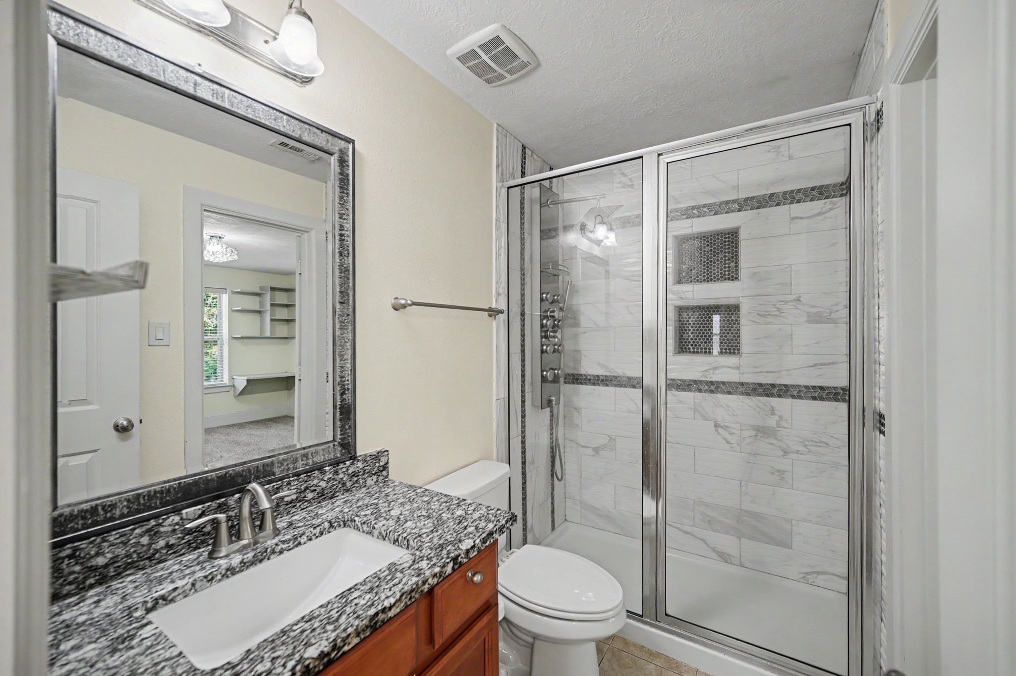 31325 Riley Woods Court Spring, TX 77386 - Photo 36 of 50 Third bath features an upgraded custom tiled shower system with built in niches and glass enclosure.