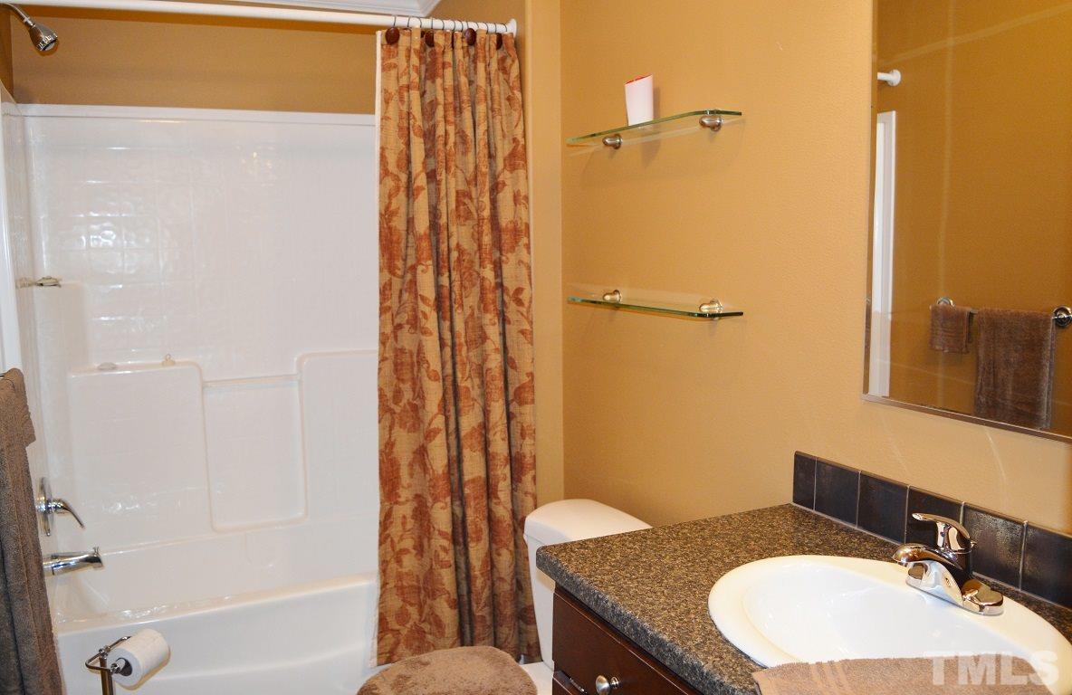 747 Glover Road Dunn, NC 28334 - Photo 15 of 25 a bathroom with a granite countertop sink toilet and shower