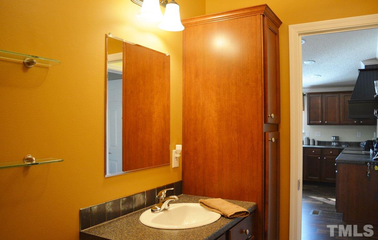 747 Glover Road Dunn, NC 28334 - Photo 16 of 25 a bathroom with a sink and a mirror