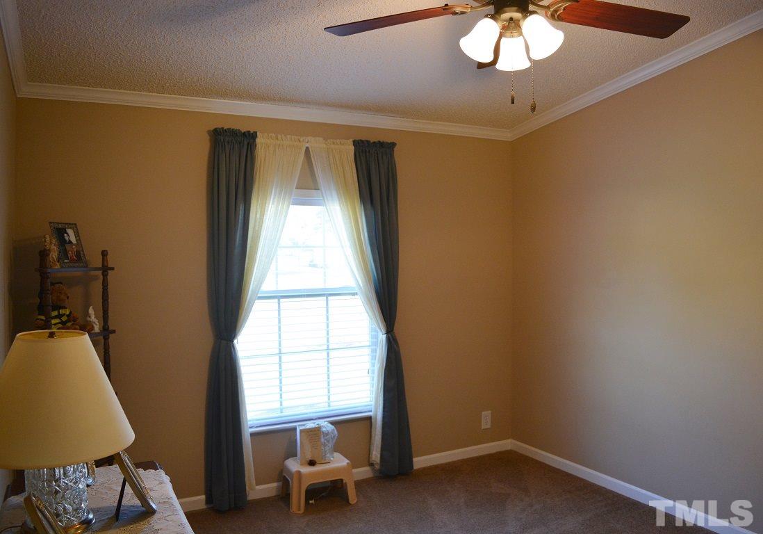747 Glover Road Dunn, NC 28334 - Photo 17 of 25 a view of a room with a window and furniture