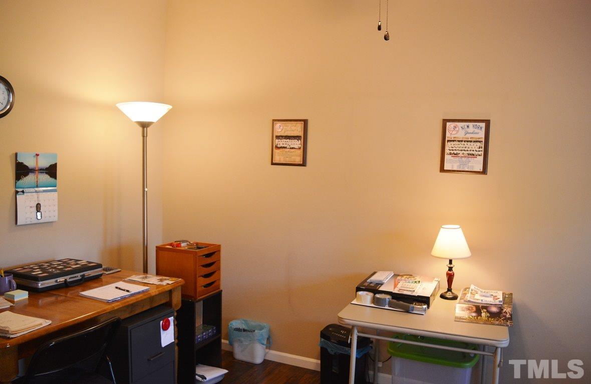 747 Glover Road Dunn, NC 28334 - Photo 18 of 25 a room with furniture and wooden floor