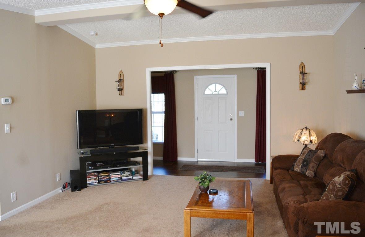 747 Glover Road Dunn, NC 28334 - Photo 4 of 25 a living room with furniture and a flat screen tv