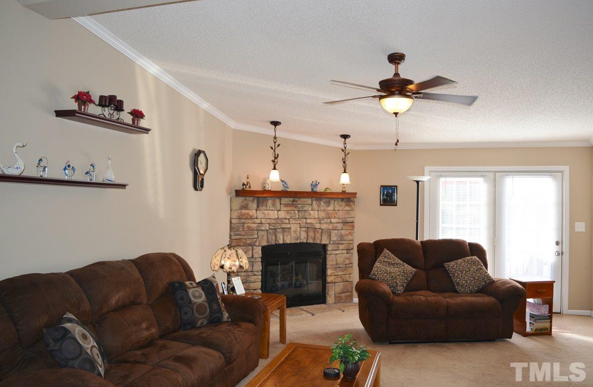 747 Glover Road Dunn, NC 28334 - Photo 5 of 25 a living room with furniture a fireplace and a window