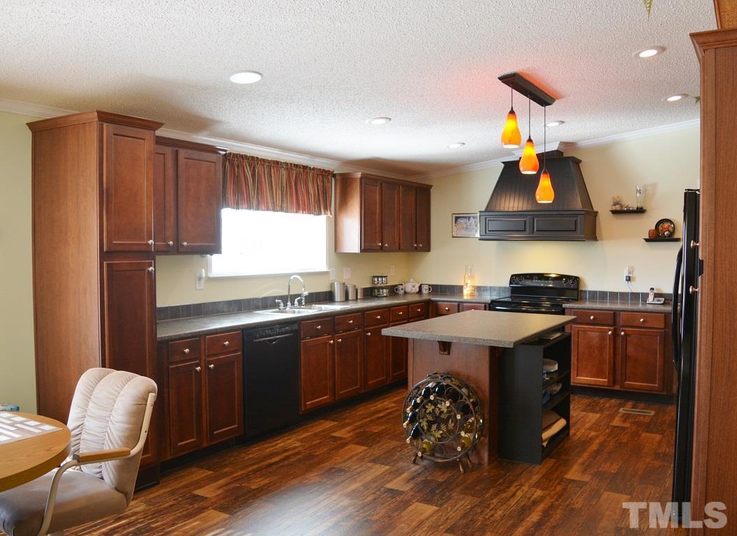 747 Glover Road Dunn, NC 28334 - Photo 6 of 25 a kitchen with a sink appliances and cabinets