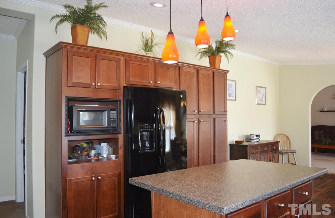747 Glover Road Dunn, NC 28334 - Photo 7 of 25 a kitchen with stainless steel appliances kitchen island granite countertop a refrigerator a stove and a dining table