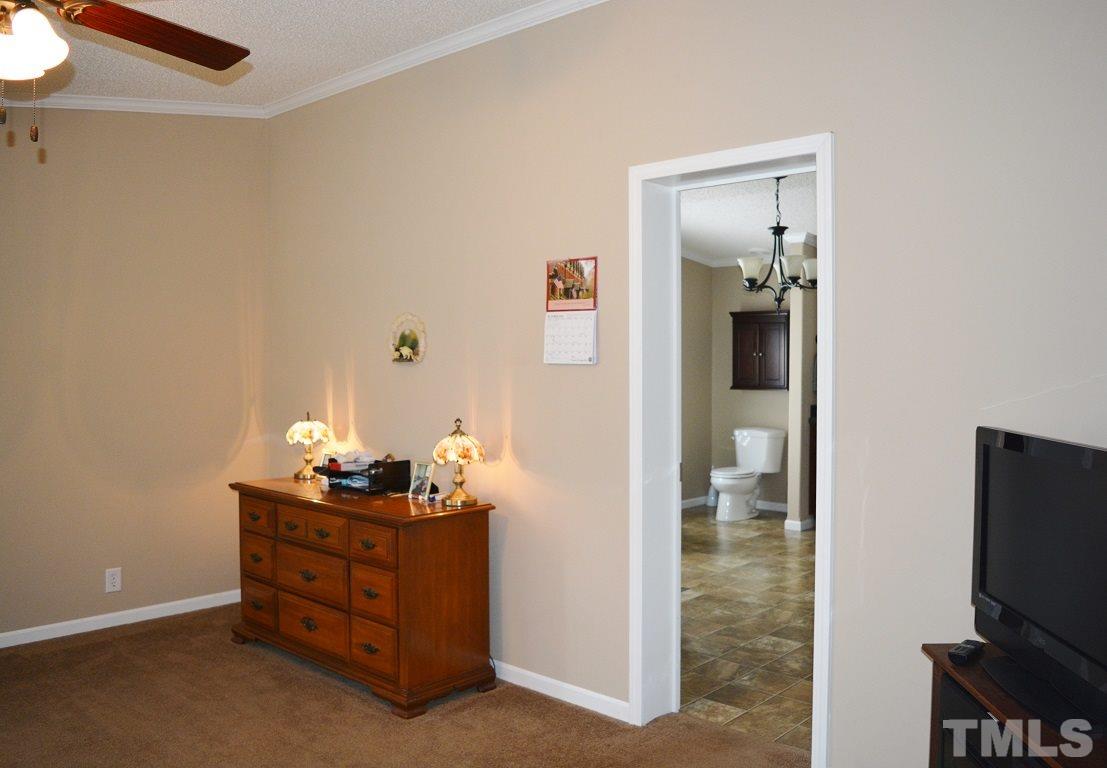 747 Glover Road Dunn, NC 28334 - Photo 10 of 25 a room with furniture and flat screen tv